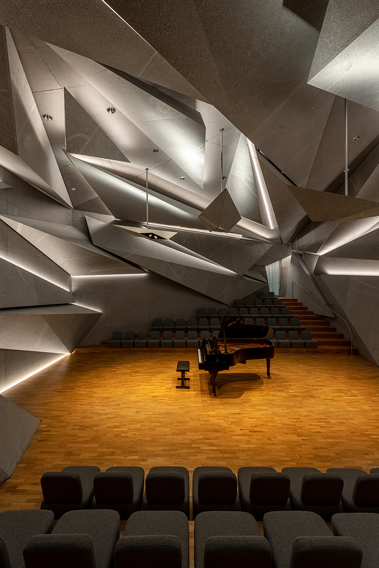 Indirectly illuminated concert hall with piano