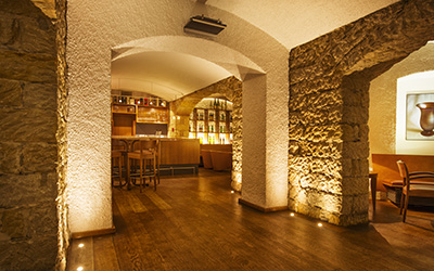 Recessed ground luminaires illuminate stone wall