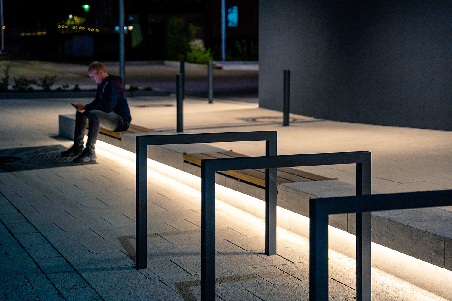 Man on an underlit bench