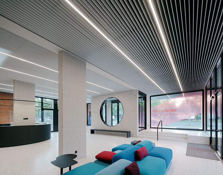 LED linear luminaires from Barthelme integrated into louvered ceiling in foyer of Federal Institute for Materials Research and Testing